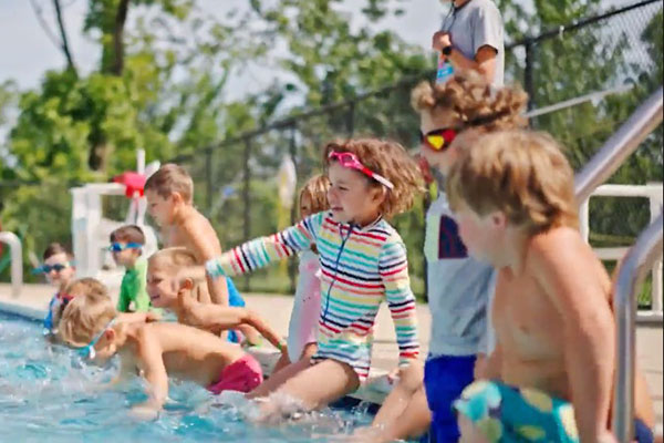 campers sitting at the pool