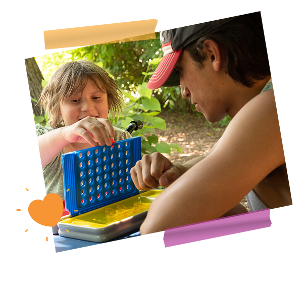 girl and staff member playing connect 4