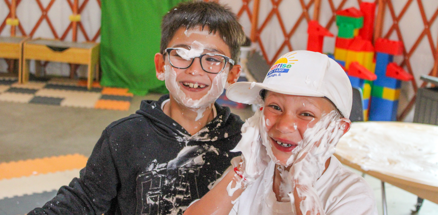 two boys playing with shaving cream