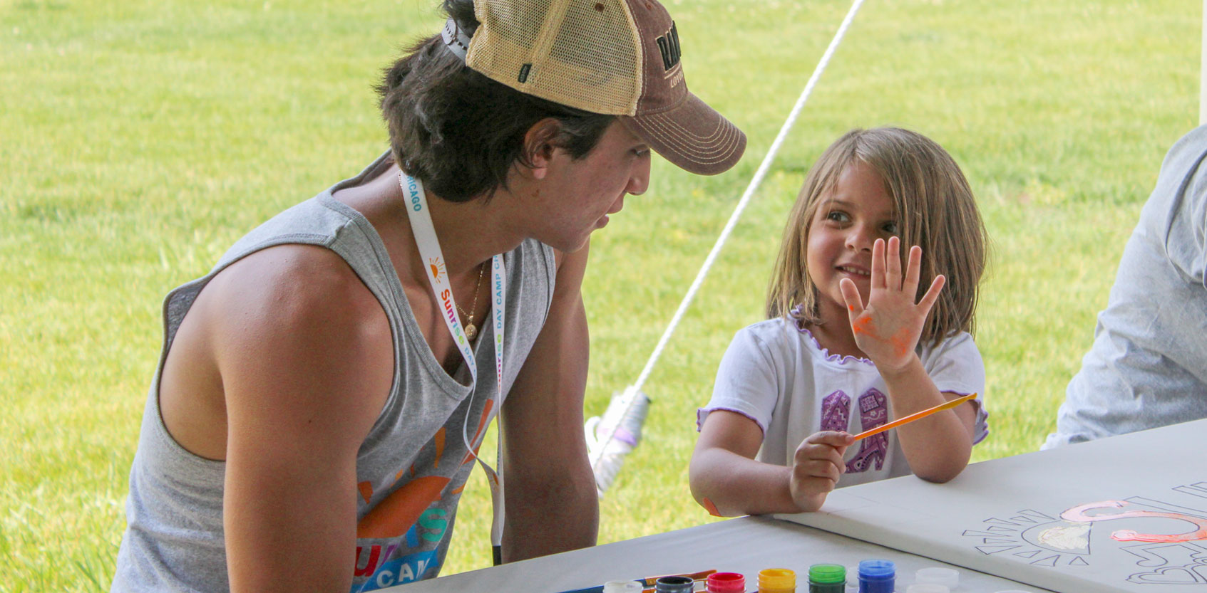camper showing counselor her hand